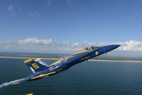 jet of navy blue angels in precision flight