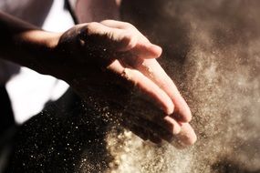 hands clapping with flour