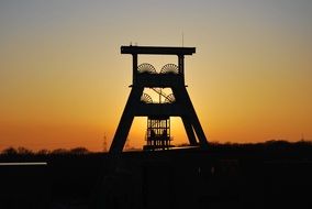 black silhouette of industrial factory at sunset