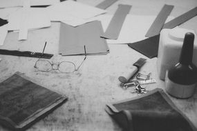 eyeglasses, arts crafts materials, black and white photo