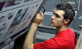 young man at printing press, tipography machine