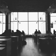 people in a restaurant in black and white image