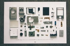 digital camera in a disassembled form on a white sheet