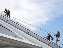 Climbers work on the wall of the building