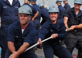 team of sailors pulling the rope