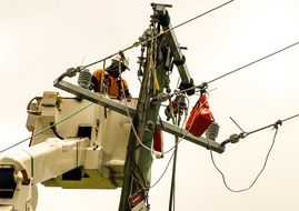 master repairing high-voltage wires