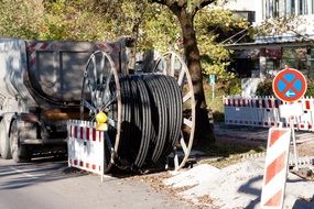 rolled plastic tube, fence and street sign, repair works