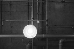 white lamp among industrial pipes