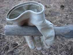 protective leather glove on wooden handle outdoor