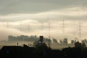 power poles in fog at farm landscape