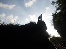 silhouettes of people on mountain