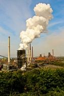 white thick smoke from a wide industrial chimney