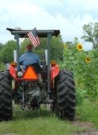 American farmer on a tractor in a rural field