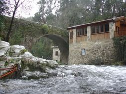 medieval bridge and windmill in Galicia, Spain