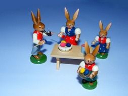 easter hares as colorful wooden figurines