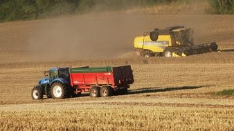 tractor and harvester in field