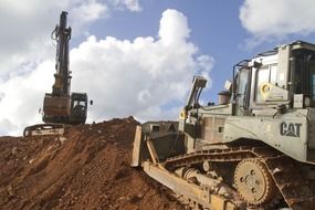 Bulldozer near the construction crane