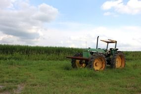 green tractor on agricultural field