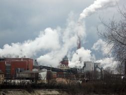 white smoke from the pipes of an industrial plant