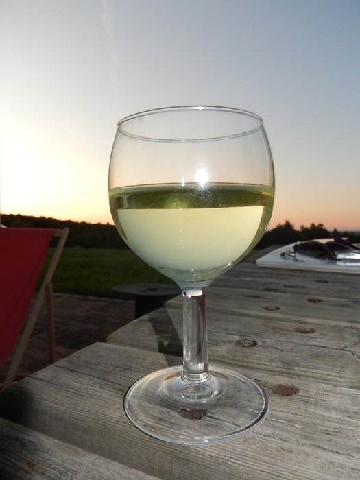 glass of white wine at dusk