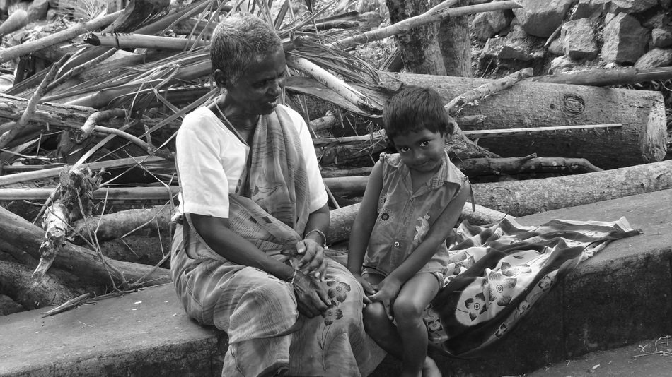 black and white photo of grandfather with a child on a bench