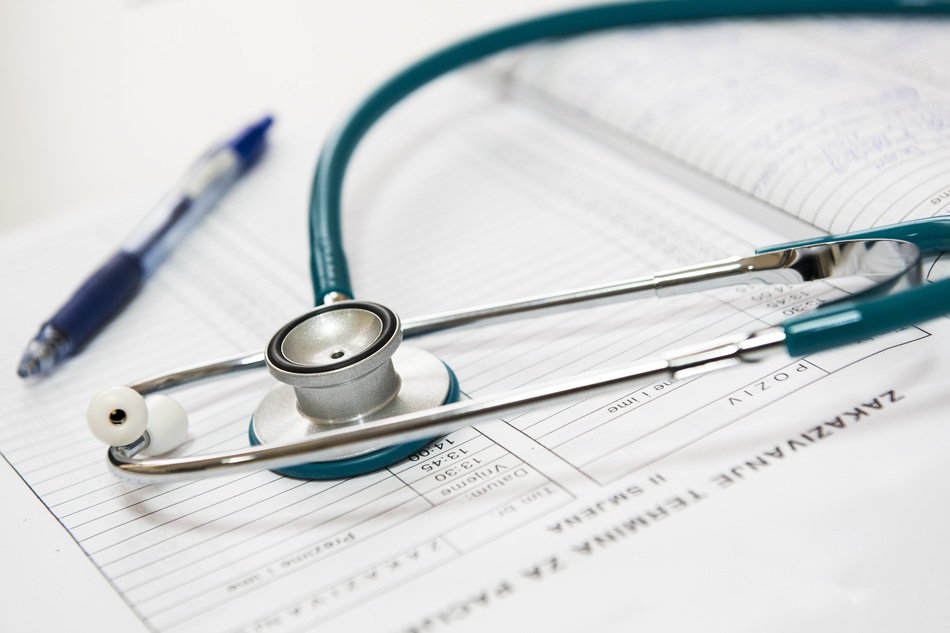 stethoscope and a pen on a medical chart