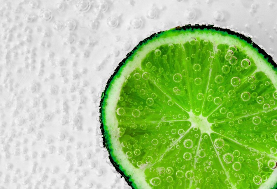 bright green piece of lime in soda water