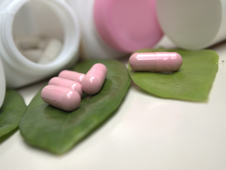 pink capsules on green leaves