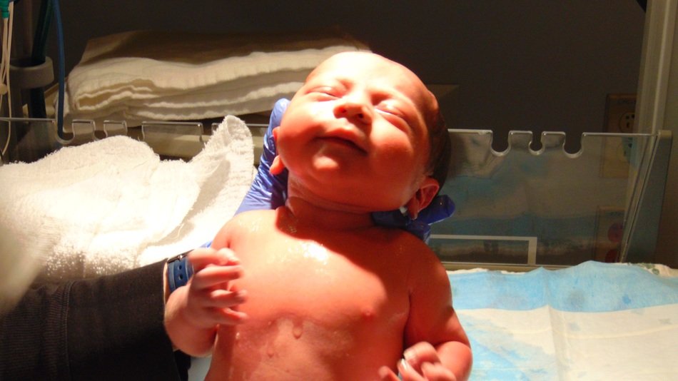 newborn baby in the hands of a nurse