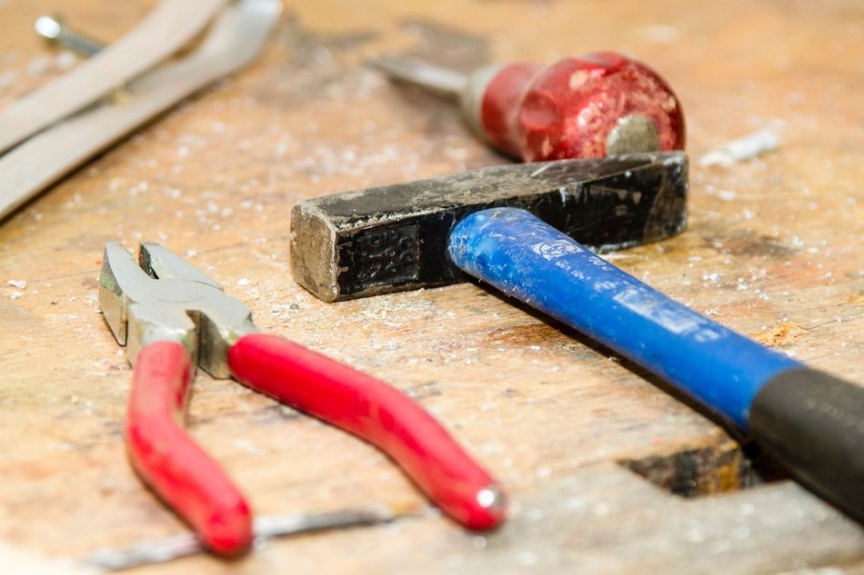 pliers and hammer on the workbench