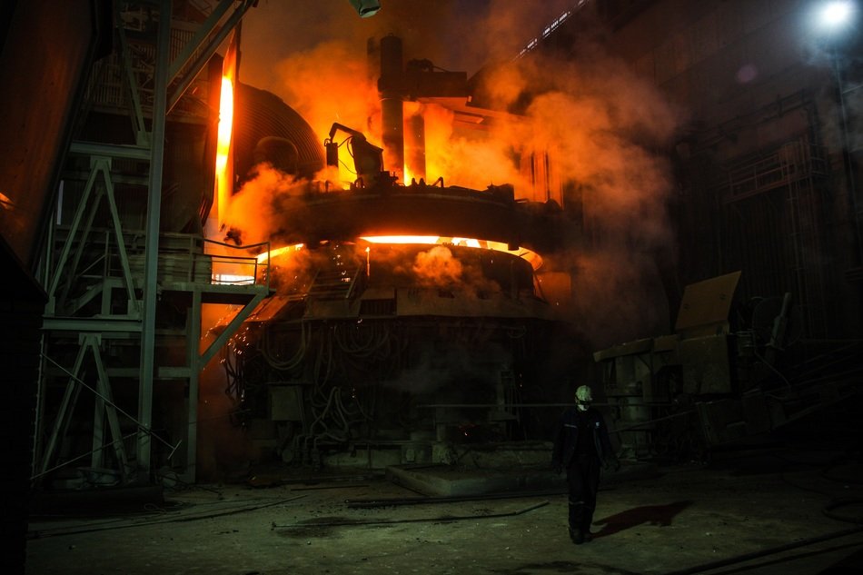 worker in front of blast furnace