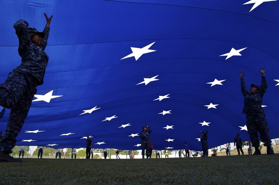 people flying a giant american flag