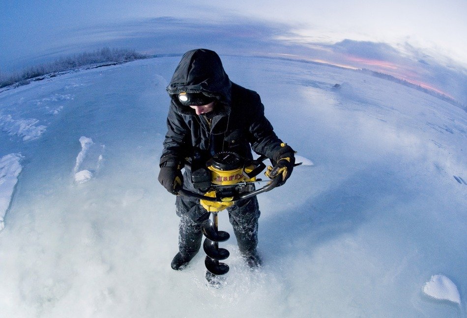 guy cuts a hole in the ice