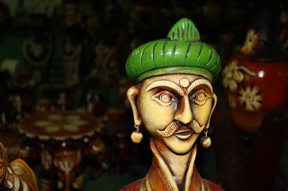 Indian statue of a man in a green hat