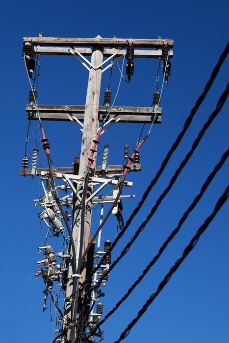 lot of cables on electric pillar at sky
