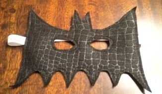stitched batman mask on the table