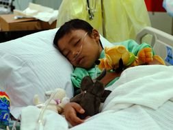 Asian child in a hospital bed