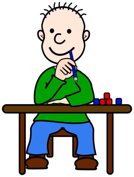 painted boy draws at the table