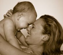 black and white photo of laughing mom and baby