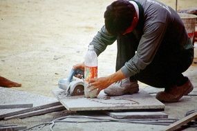 workers cut the tile