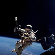 Cosmonaut in space suit in outer space