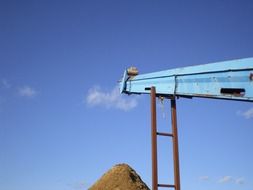 conveyor belt at sky over pile