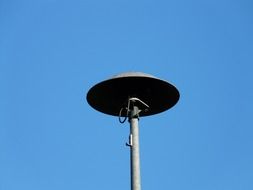 mechanical fire siren against the sky