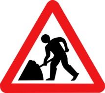 painted triangular road works as a sign