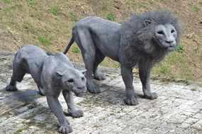 stone statue of a lion and lioness