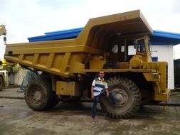 yellow dump truck and men