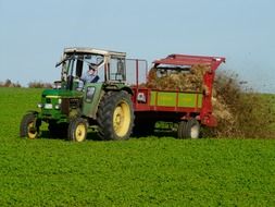 Tractor fertilizes the field