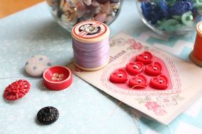making postcards from buttons and vintage threads