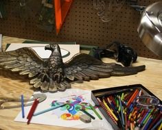 figurine eagle and colored pencils