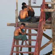 group of asian men on wooden pier, myanmar